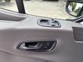 Interior door panel of a 2020 Ford Transit 250 showing the window control and door handle
