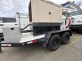 A 2005 Katolight SED60FPJ4 generator mounted on a trailer with a diamond plate storage box on the side and large wheels for mobility
