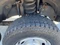 Close-up of a tire and suspension system from a 2016 Ford F-250 SD showing tread pattern and metal components