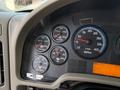 The dashboard of a 2011 International WorkStar displaying various gauges for RPM water temperature oil pressure and transmission temperature