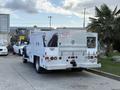 A 2008 Ford F-450 flatbed truck with a custom utility body features multiple compartments and utility connections ready for service