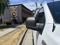 A white 2019 Ford F-150 pickup truck is shown from the side with a focus on the side mirror and antenna