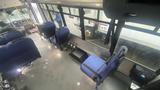 Interior view of a 2021 Ford Transit with blue seats arranged towards the front and a gray floor visible among the seating area