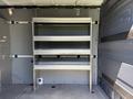 A 2019 Mercedes-Benz Sprinter van interior with a metal shelving unit featuring four shelves