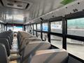 Interior of a 2007 Freightliner B2 school bus showing rows of gray seats facing forward with windows along the side