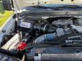 A 2009 Ford F-550 engine bay showcasing components like the VMAC air compressor and various hoses and wiring