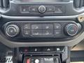 Control panel of a 2017 Chevrolet Colorado featuring climate controls radio buttons and additional features like a traffic advisor system