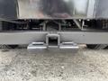 A close-up view of a heavy-duty hitch receiver mounted on the rear bumper of a 2015 Chevrolet Silverado 3500HD