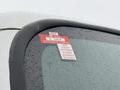 A close-up of a 2019 Freightliner M2 side mirror displaying a red and white certificate of approval sticker with months listed from July to December
