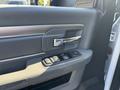 The interior door panel of a 2014 RAM 5500 featuring a handle and power window controls