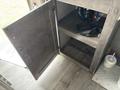 An open storage cabinet in a 2021 Jayco Jay Flight with visible shelves and plumbing components inside