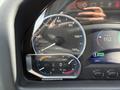 Dashboard of a 2022 Lion Lion6 showing a speedometer in kilometers per hour and a battery charge indicator displaying 100% charge