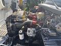 Close-up of a 2014 Freightliner M2 106 engine showing components like the radiator hoses fuel filter and various wires and pipes connected to the engine assembly