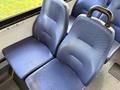 Two blue upholstered seats with textured surfaces and a handle on the side
