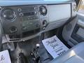 Interior dashboard of a 2017 Ford F-650 Super Duty featuring radio controls climate vents and gear shift with a floor mat that says Thank You Its Been Pleasure Serving You