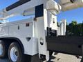 2013 International 7500 truck featuring a large white body and a raised hydraulic lift arm on the side