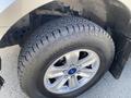 The image shows a close-up view of a 2015 Ford F-150 tire with a Hankook brand tread design and a silver alloy wheel