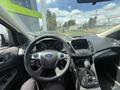 Interior view of a 2015 Ford Escape featuring a steering wheel dashboard and center console