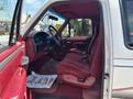 Interior of a 1995 Ford F-250 with red fabric seats and red accents visible in the front cab area