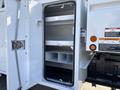 A 2019 Freightliner M2 106 truck with an open storage compartment featuring several shelves inside
