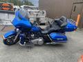 A blue 2017 Harley-Davidson FLHTKL motorcycle featuring a full front fairing and a spacious seat for two riders