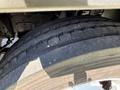 Close-up of a tire on a 2012 Isuzu NPR HD showing tread pattern and texture