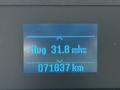 Display screen showing average fuel consumption of 31.8 liters per 100 kilometers and total distance traveled of 71837 kilometers in a 2021 Ford Econoline