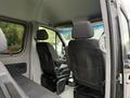 Interior view of a 2017 Mercedes-Benz Sprinter showing two black fabric front seats with headrests and storage pockets on the back