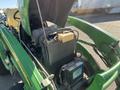 A 2008 John Deere 3320 300X tractor with its hood open revealing the engine compartment and components like the radiator and battery