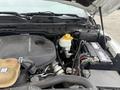 A 2016 RAM 1500 engine bay showing the EcoDiesel V6 engine components including the engine cover battery and coolant reservoir