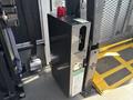 A black storage unit with a red light on top designed for emergency use attached to the interior of a vehicle