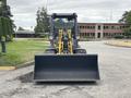 A 2014 Wacker Neuson WL34 compact wheel loader with a large front bucket ready for digging or moving materials
