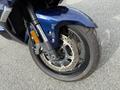 A close-up of the front wheel of a 2016 Yamaha FJR1300AE motorcycle showing the disc brake and tire details