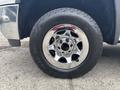 Close-up of a chrome wheel rim with a black tire featuring the Hercules brand on a 2016 GMC Sierra 1500