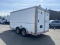 A white 2008 Wells Industries Inc EW1422 trailer with dual rear doors and a rounded top, featuring four wheels and a sturdy frame