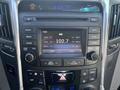 The interior dashboard of a 2014 Hyundai Sonata featuring a radio display with various buttons and controls