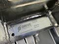 A metal identification plate with the text "DRIVE PRODUCTS" along with the serial number "1214-230" and model number "KK212714" prominently displayed