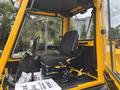 A yellow 2004 Bombardier SW48 vehicle cabin featuring a black driver's seat control levers and pedals
