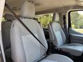 Interior seats of a 2016 Ford Transit 150 with grey upholstery and seat belts visible