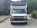 A 2020 Chevrolet Express with a white exterior and large box structure in the front view