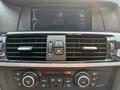 Dashboard of a 2013 BMW X3 featuring air conditioning controls and a display screen