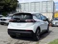 A 2023 Chevrolet Bolt EV in white with a sleek design showcasing its rear view and modern features