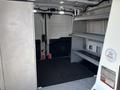 Interior of a 2019 Ford Transit 350 van showing empty cargo space with metal shelving on the right and a rubber floor