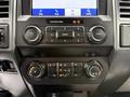 Dashboard controls of a 2022 Ford F600 featuring audio and climate control knobs and a touchscreen display
