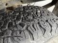 Close-up of a worn tire tread on a 2014 Ford F-150 showing deep grooves and patterns designed for traction and off-road performance