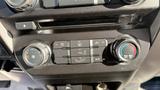 Dashboard control panel of a 2016 Ford F-150 featuring air conditioning and climate control buttons