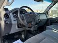 Interior view of a 2012 Ford F-350 SD showing the steering wheel dashboard and front seats with a focus on the control panel and gear shift