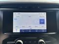 Dashboard display of a 2021 Ford F-150 showing radio settings and frequency options