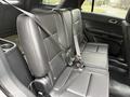 A 2019 Ford Explorer features a black leather interior with rear bench seats and seatbelts visible