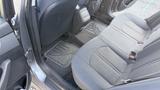Interior of a 2018 Hyundai Sonata showing the back seat area with fabric upholstery and floor mats